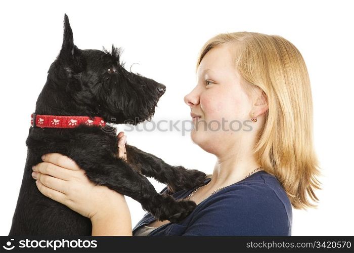 Beautiful teenage girl holds her Scotty dog nose to nose. Isolated on white.