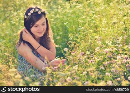 Beautiful teenage girl on the summer field