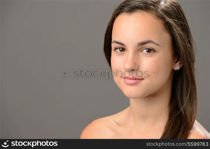 Beautiful teenage girl skin care cosmetics on gray background