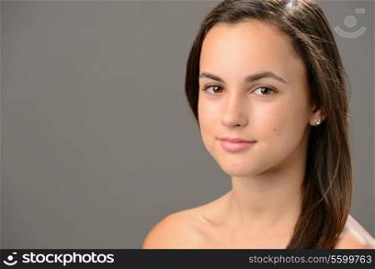 Beautiful teenage girl skin care cosmetics on gray background
