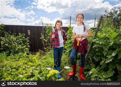 Beautiful teenage girls working in garden at sunny day