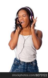 Beautiful teenager happily singing along jamming while listening to music, on white.