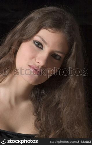 Beautiful teenager on black background