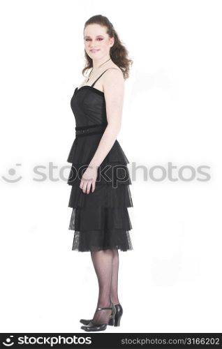 Beautiful teenager standing on white background in party dress