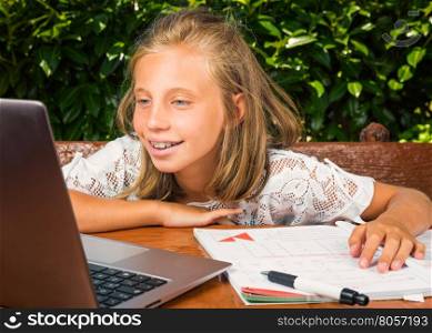 Beautiful teenager student, 10 years old,happiness studying on the computer.