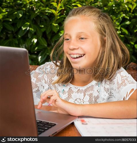 Beautiful teenager student,10 years old, have good news on the computer screen
