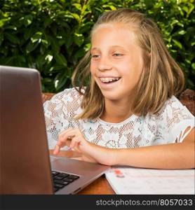 Beautiful teenager student,10 years old, have good news on the computer screen