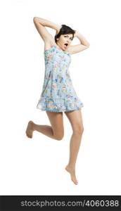 Beautiful teenager with a blue dress dancing and jumping, isolated over white background