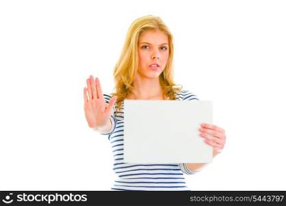 Beautiful teengirl holding blank paper sheet and showing stop gesture&#xA;