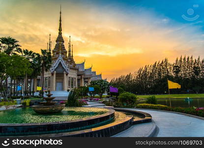 Beautiful temple thailand dramatic colorful sky twilight sunset / Landmark Nakhon Ratchasima province temple at Wat None Kum in Thailand with yellow sky