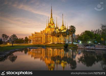 Beautiful temple thailand dramatic colorful sky twilight sunset shadow on water reflection - Landmark Nakhon Ratchasima province temple at Wat None Kum in Thailand