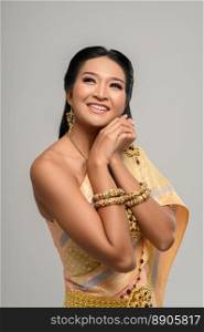 Beautiful Thai woman wearing a Thai dress and a happy smile.