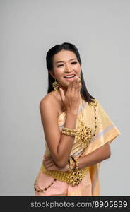 Beautiful Thai woman wearing a Thai dress and a happy smile.