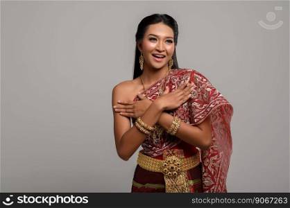Beautiful Thai woman wearing a Thai dress and a happy smile.