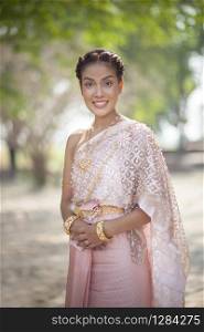 beautiful thai woman wearing old thai tradition clothes style holding bamboo wood umbrella with toothy smiling face