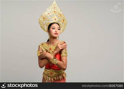 Beautiful Thai woman wearing Thai dress and looking at the top