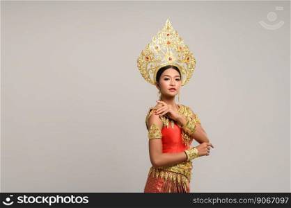 Beautiful Thai woman wearing Thai dress and looking to the side