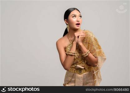Beautiful Thai women wearing Thai dress and looking at the top