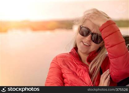 Beautiful thoughtful enigmatic, teenage girl or young woman poses outside with sunglasses