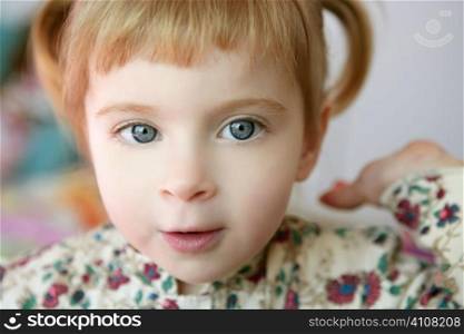 Beautiful toddler blond girl looking and smilint to camera