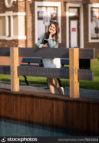 Beautiful tourist woman at Amsterdam using tablet on street