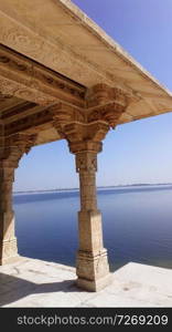 beautiful traditional  building from white carving  stone at lake. Rajasthan , India