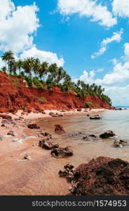 Beautiful tranquil tropical island red cliff rock beach with blue sky and clouds in summer, tranquil serene ocean scenery. Fang Daeng in Prachuap Khiri Khan. Thailand