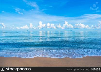 Beautiful tropical beach sea ocean with white cloud blue sky and copyspace for leisure travel in holiday vacation concept