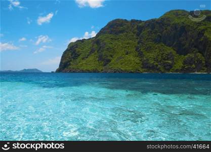 Beautiful tropical sea bay. Scenic landscape with blue lagoon and mountain island, El Nido, Palawan, Philippines, Southeast Asia. Exotic scenery. Popular landmark, tourist destination of Philippines