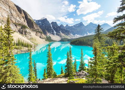 Beautiful turquoise waters of the Moraine lake with snow-covered peaks above it in Banff National Park of Canada