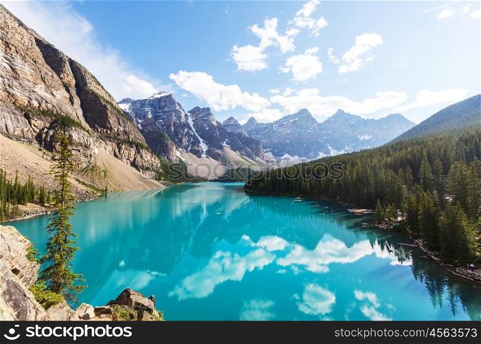 Beautiful turquoise waters of the Moraine lake with snow-covered peaks above it in Banff National Park of Canada