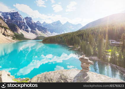 Beautiful turquoise waters of the Moraine lake with snow-covered peaks above it in Banff National Park of Canada