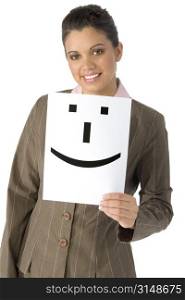 Beautiful twenty year old business woman holding up smiley on white paper.