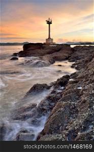Beautiful twilight seascape with lighthouse on the island