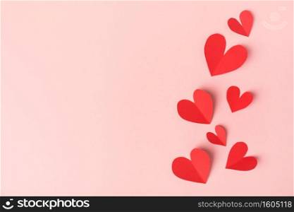 Beautiful valentines day paper hearts on pink background. View from above. Valentines Day Concept. 