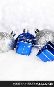Beautiful various blue and silver christmas decor on snow close-up