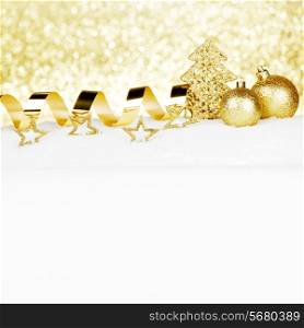Beautiful various golden christmas decor on snow close-up