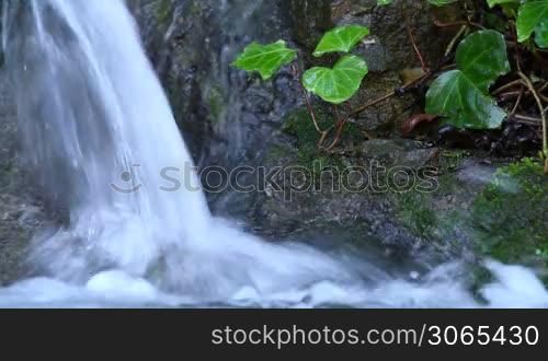 Beautiful veil cascading waterfall, mossy rocks
