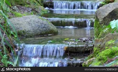 Beautiful veil cascading waterfall, mossy rocks