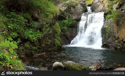 Beautiful veil cascading waterfall, mossy rocks