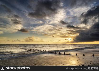 Beautiful vibrant seascape at sunset image with dramatic sky