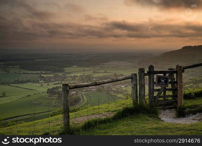 Beautiful vibrant sunrise over rolling countryside landscape