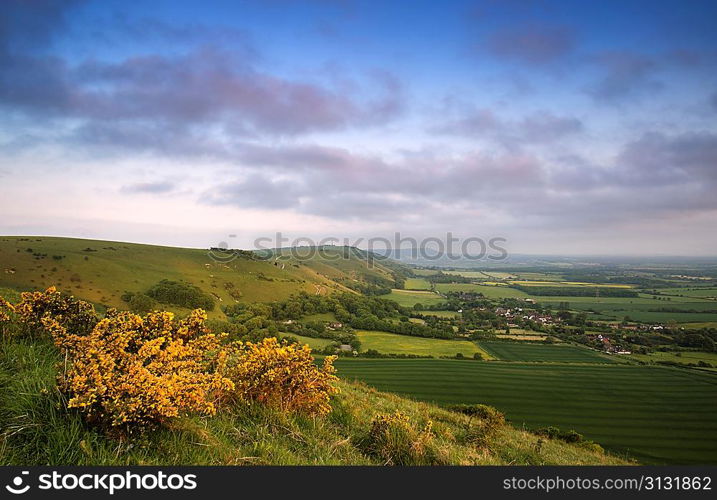 Beautiful vibrant sunrise over rolling countryside landscape