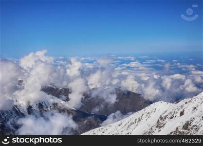Beautiful view above the clouds over mountains and valley. Great view of the foggy Ala-Archa National Park in Kyrgyzstan.