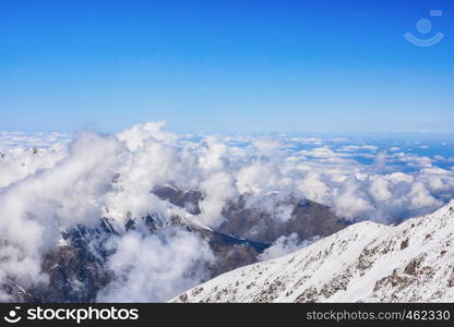 Beautiful view above the clouds over mountains and valley. Great view of the foggy Ala-Archa National Park in Kyrgyzstan.