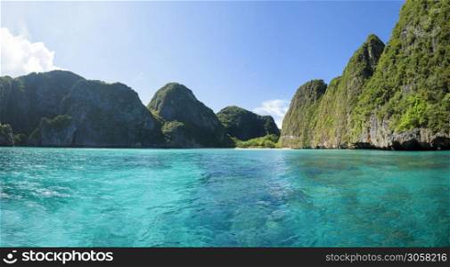 Beautiful view landscape of tropical beach , emerald sea and white sand against blue sky, Maya bay in phi phi island , Thailand .. Beautiful view landscape of tropical beach , emerald sea and white sand against blue sky, Maya bay in phi phi island , Thailand