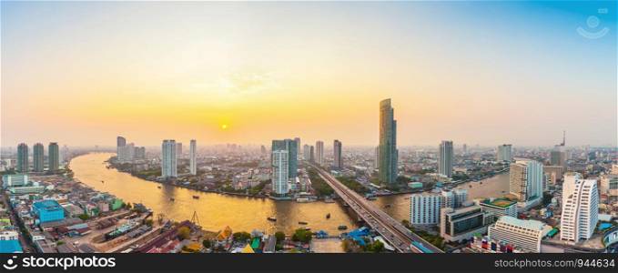 Beautiful view of Bangkok city with Chaopraya river at sunset. Panorama photo.