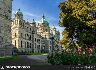Beautiful view of British Columbia Parliament Buildings with rose flowerbed in Victoria, Canada