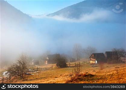 Beautiful view of Carpathians mountains village in a morning fog