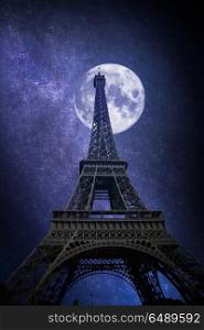 Beautiful view of famous Eiffel Tower in Paris, France. The stars and the moon shine at night.. Eiffel Tower in Paris, France